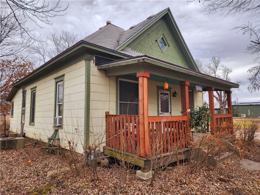 view of home's exterior with cooling unit, covered porch, and central AC