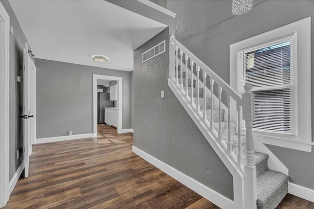 stairs with hardwood / wood-style flooring