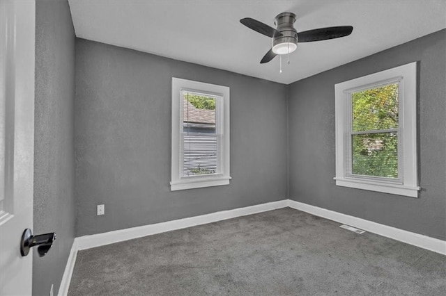 carpeted spare room with ceiling fan