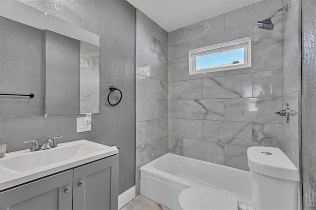 full bathroom featuring vanity, toilet, and tiled shower / bath combo