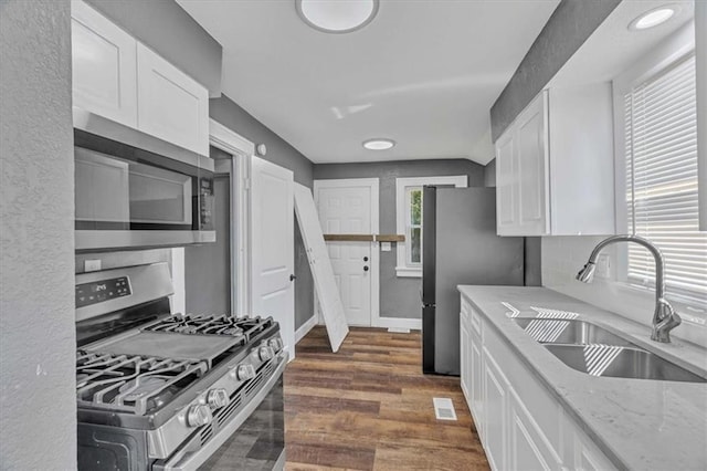 kitchen featuring white cabinetry, sink, dark hardwood / wood-style flooring, and appliances with stainless steel finishes