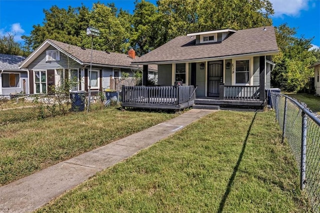 bungalow-style house featuring a porch and a front lawn