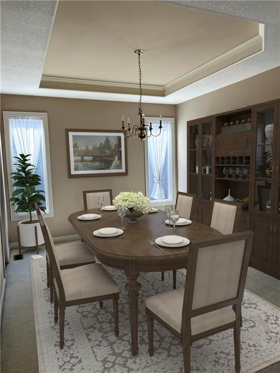 dining area with a raised ceiling, light carpet, ornamental molding, and an inviting chandelier