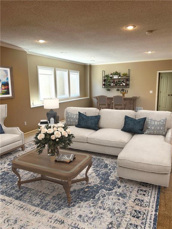 living room with baseboards, a textured ceiling, carpet floors, and crown molding