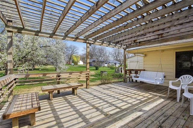 wooden deck featuring a shed, a pergola, a yard, and an outdoor structure