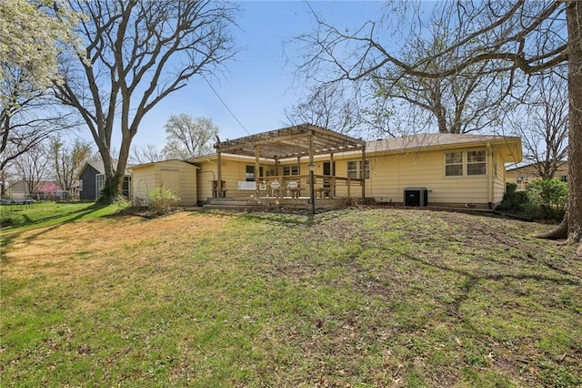 back of property with a trampoline, a pergola, a wooden deck, a yard, and central air condition unit