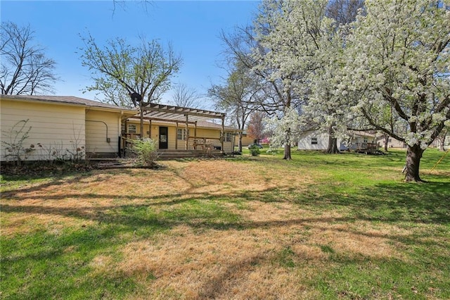view of grassy yard with a pergola