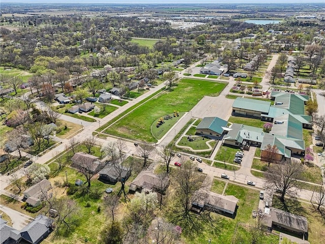 aerial view of property and surrounding area featuring nearby suburban area and a large body of water
