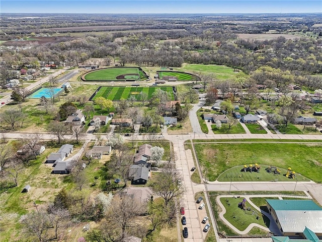 aerial view of property and surrounding area with nearby suburban area