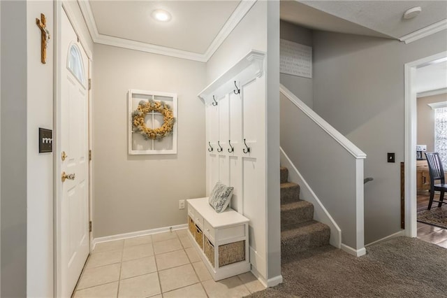 mudroom featuring light tile patterned floors, ornamental molding, and baseboards