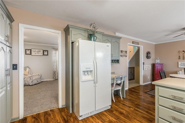 kitchen featuring green cabinets, white refrigerator with ice dispenser, dark wood-type flooring, and crown molding