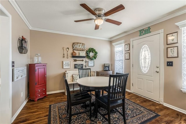 dining space featuring ceiling fan, ornamental molding, dark wood-style flooring, and baseboards