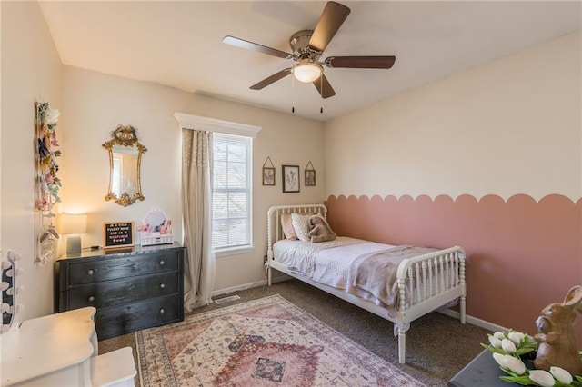 bedroom with ceiling fan, carpet, and baseboards