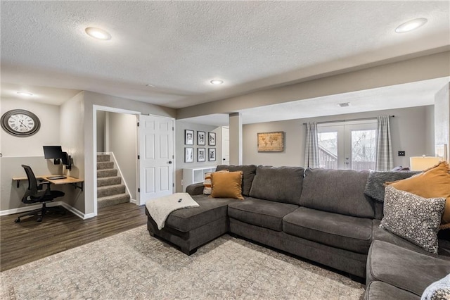 living area featuring a textured ceiling, french doors, wood finished floors, and baseboards