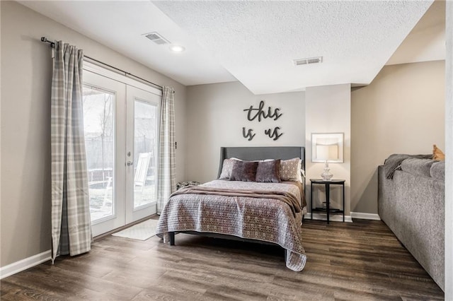 bedroom with access to exterior, dark wood-style flooring, visible vents, and french doors