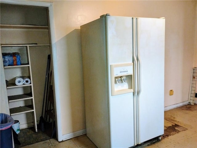 interior space featuring white fridge with ice dispenser