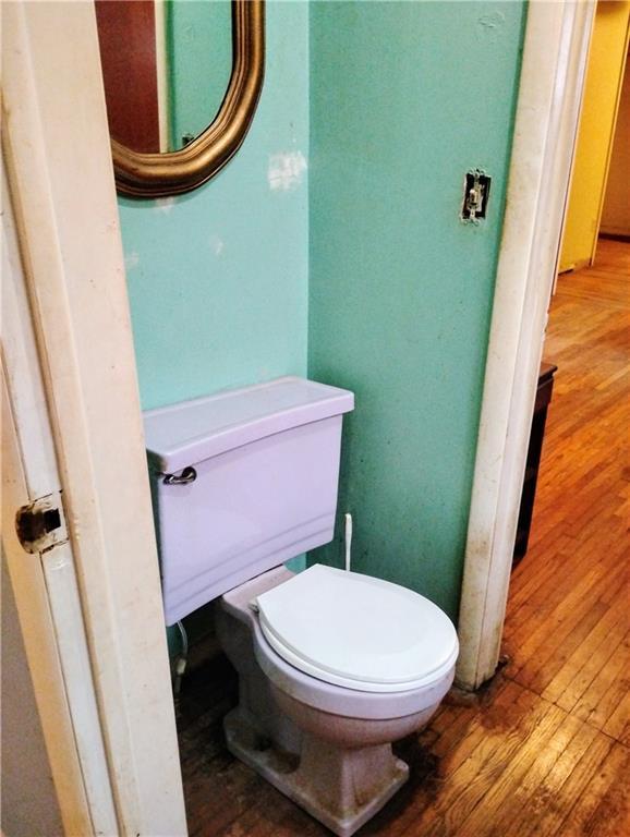 bathroom with hardwood / wood-style floors and toilet