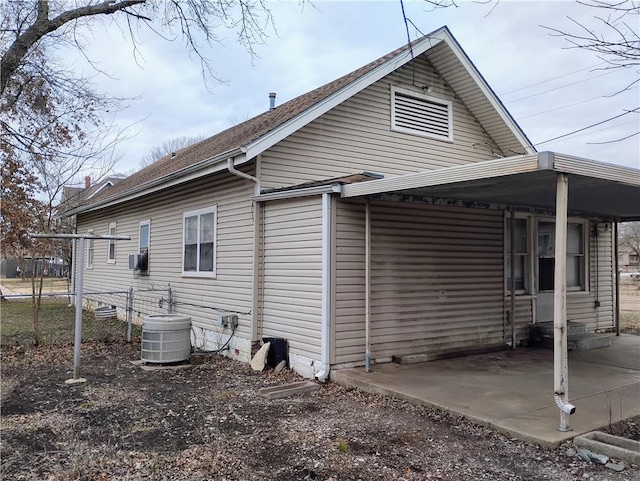 view of side of property featuring central AC unit and a patio