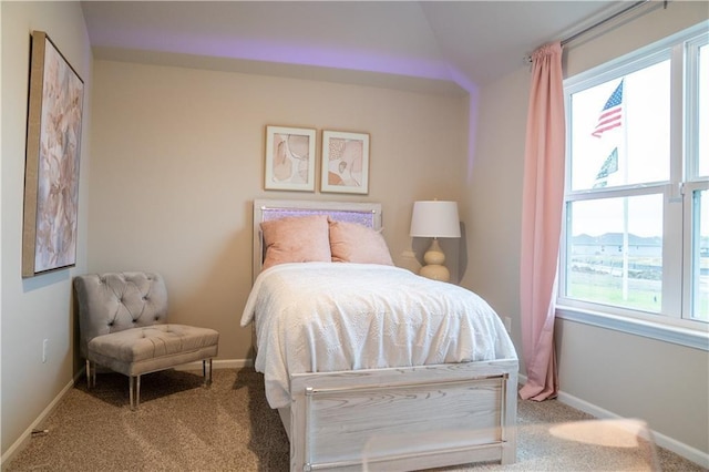 bedroom featuring light carpet and lofted ceiling