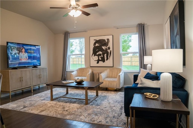 living room with dark wood-type flooring, vaulted ceiling, and ceiling fan