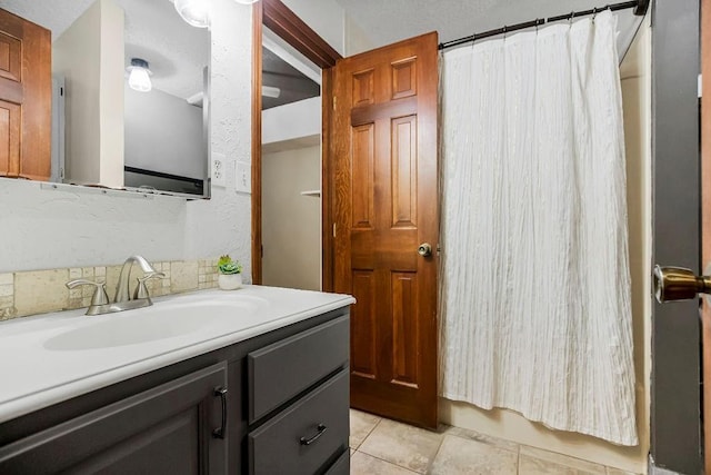 bathroom featuring a shower with curtain, tile patterned floors, and vanity