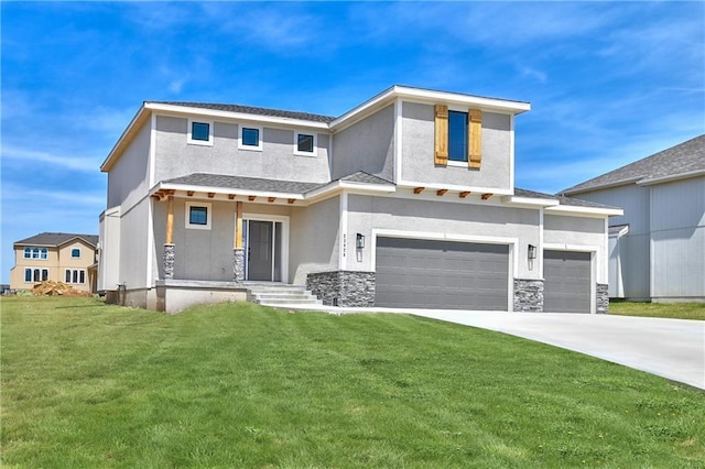 view of front of property with a garage and a front lawn