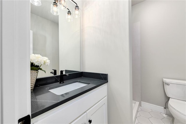 bathroom with vanity, a shower, tile patterned floors, and toilet