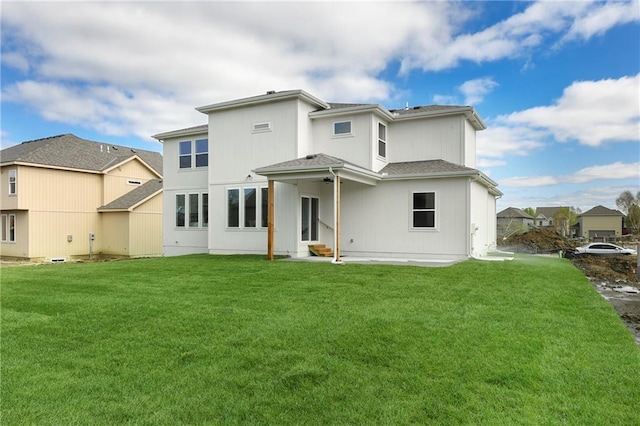 rear view of house featuring a yard and a patio