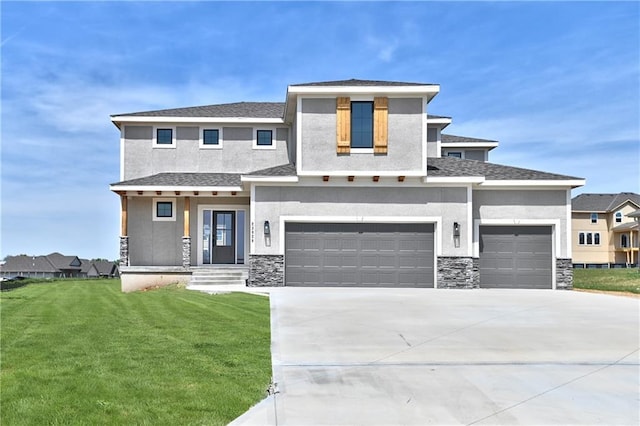 view of front of property featuring a garage and a front lawn