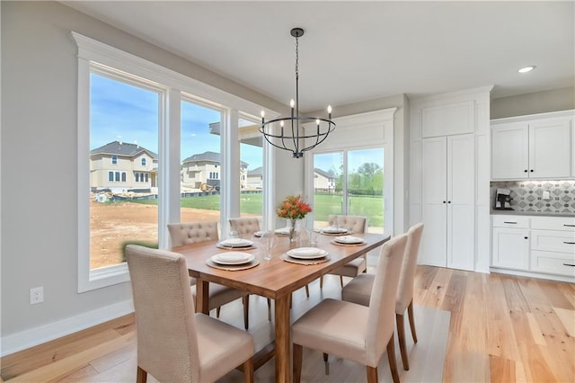 dining room featuring a notable chandelier and light hardwood / wood-style flooring