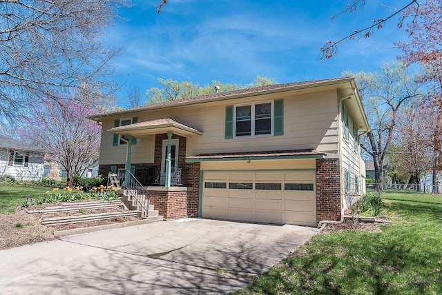 split foyer home featuring a garage and a front yard