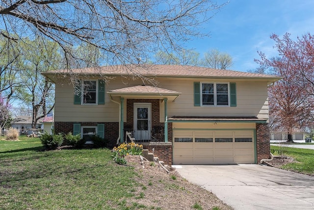 bi-level home with a garage and a front lawn