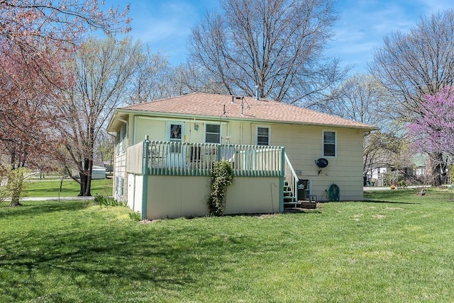 back of property with a yard and a deck