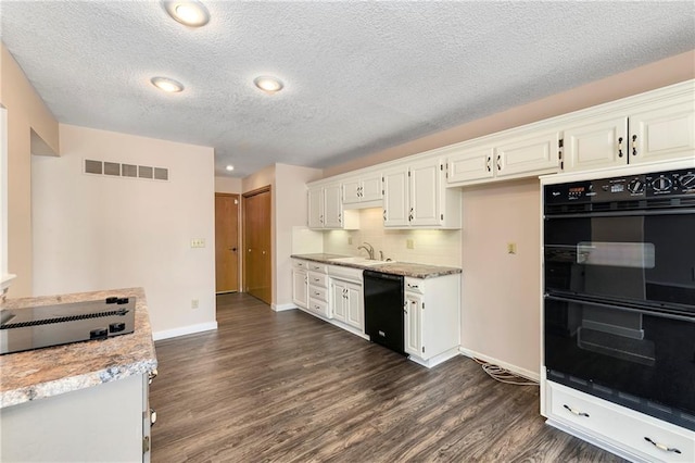 kitchen with visible vents, white cabinets, dark wood-style flooring, black appliances, and a sink