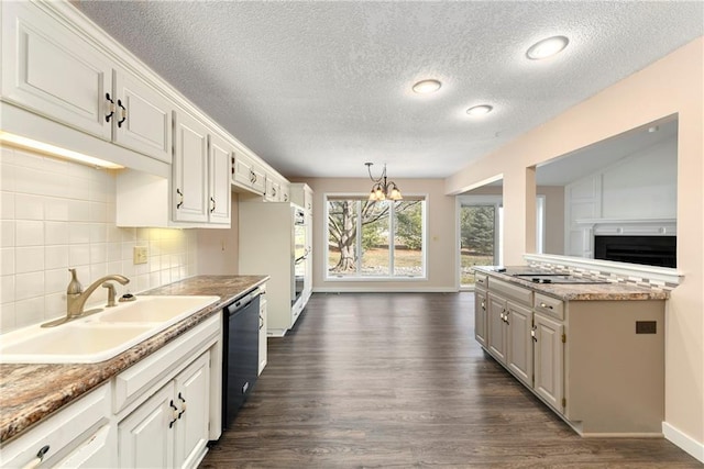 kitchen with dark wood-style flooring, a sink, dishwasher, tasteful backsplash, and an inviting chandelier