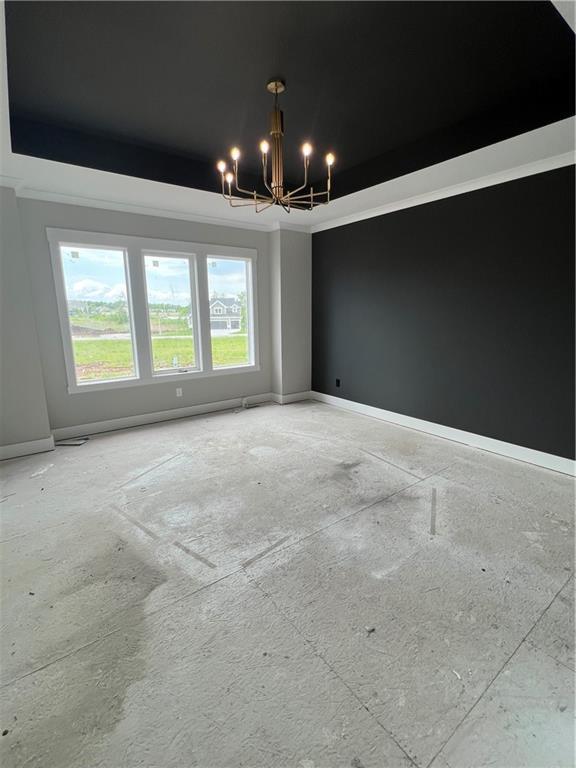 2209 W 176th Pl, Overland Park, KS 66085 - spare room with a chandelier and baseboards