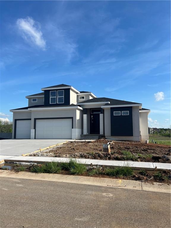 2209 W 176th Pl, Overland Park, KS 66085 - prairie-style home featuring driveway, a garage, and stucco siding