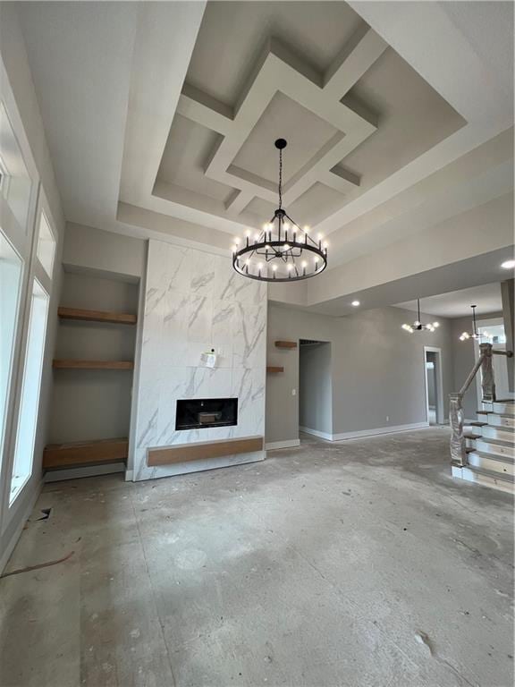2209 W 176th Pl, Overland Park, KS 66085 - unfurnished living room with a chandelier, a premium fireplace, healthy amount of natural light, stairs, and coffered ceiling