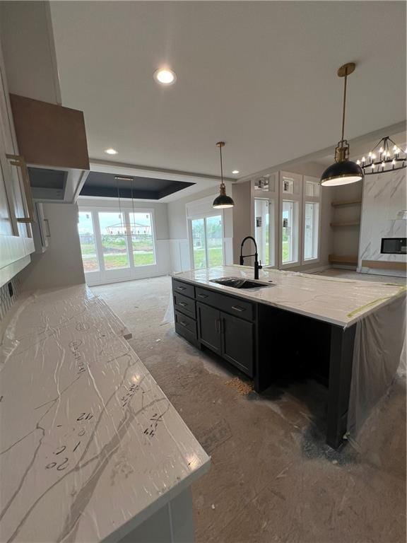 2209 W 176th Pl, Overland Park, KS 66085 - kitchen featuring a sink, a kitchen island with sink, dark cabinets, recessed lighting, and light stone counters