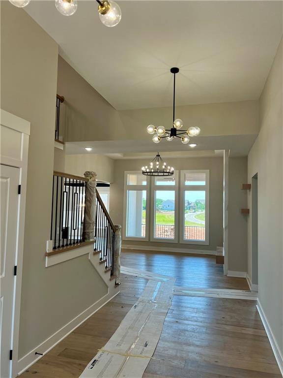 2209 W 176th Pl, Overland Park, KS 66085 - entryway with a chandelier, wood finished floors, and stairs