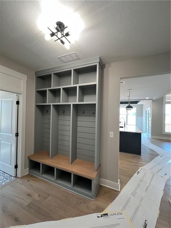 2209 W 176th Pl, Overland Park, KS 66085 - mudroom with wood finished floors and a textured ceiling