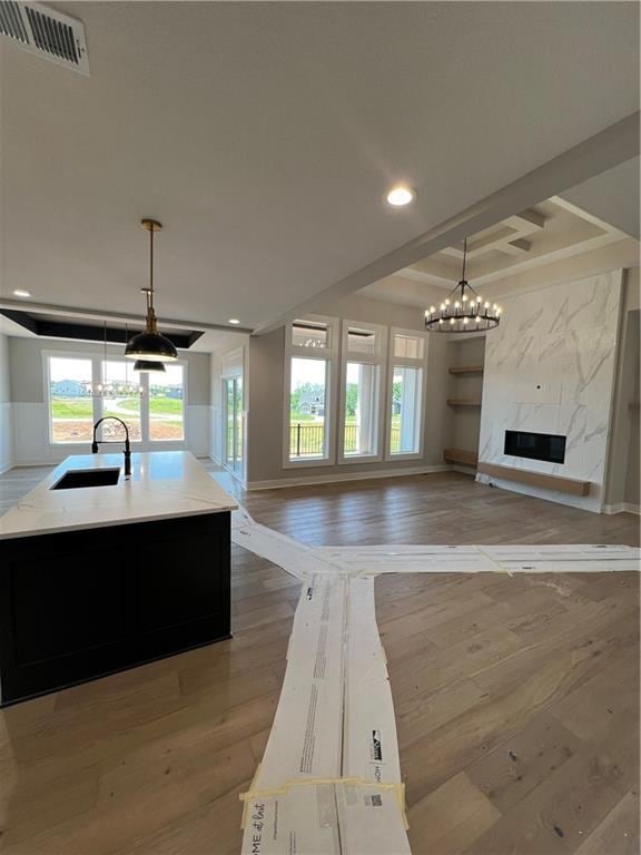 2209 W 176th Pl, Overland Park, KS 66085 - kitchen featuring light wood-style flooring, open floor plan, a chandelier, plenty of natural light, and recessed lighting