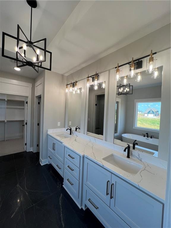 2209 W 176th Pl, Overland Park, KS 66085 - bathroom featuring a chandelier, double vanity, marble finish floors, and a freestanding tub