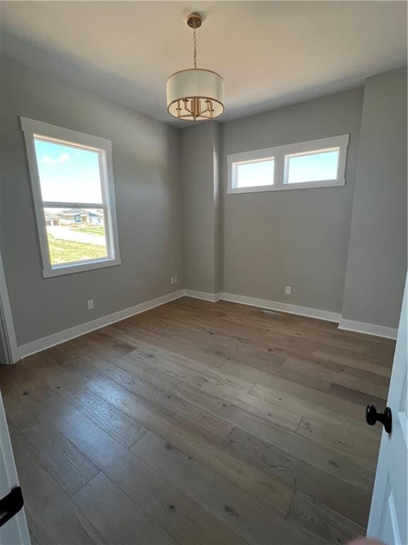 2209 W 176th Pl, Overland Park, KS 66085 - spare room featuring hardwood / wood-style floors and a chandelier