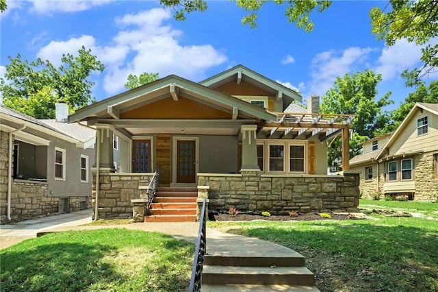 craftsman-style house with a front yard and covered porch