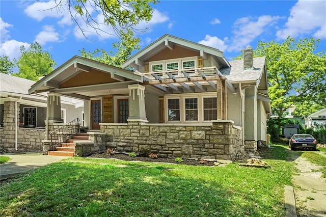 rear view of house featuring a pergola, a yard, and a porch