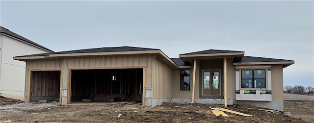 view of front of home featuring an attached garage and french doors