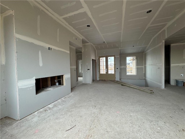 unfurnished living room featuring french doors