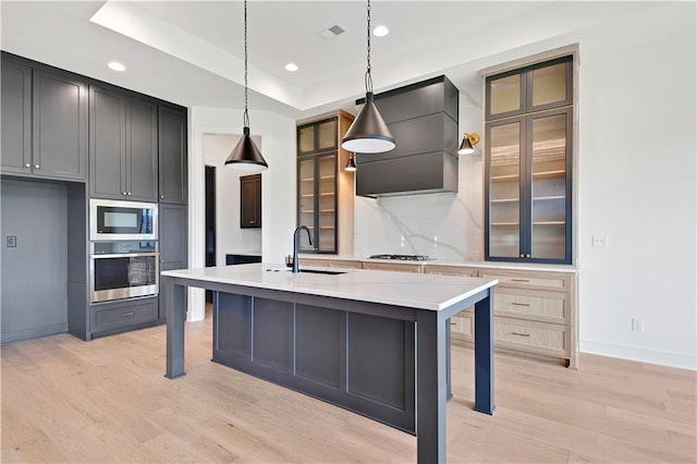 24909 W 98th Pl, Lenexa, KS 66227 - kitchen with stainless steel appliances, wall chimney range hood, light wood-style floors, backsplash, and glass insert cabinets