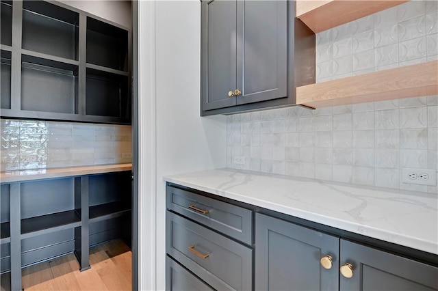 24909 W 98th Pl, Lenexa, KS 66227 - kitchen featuring gray cabinets, light stone countertops, and tasteful backsplash